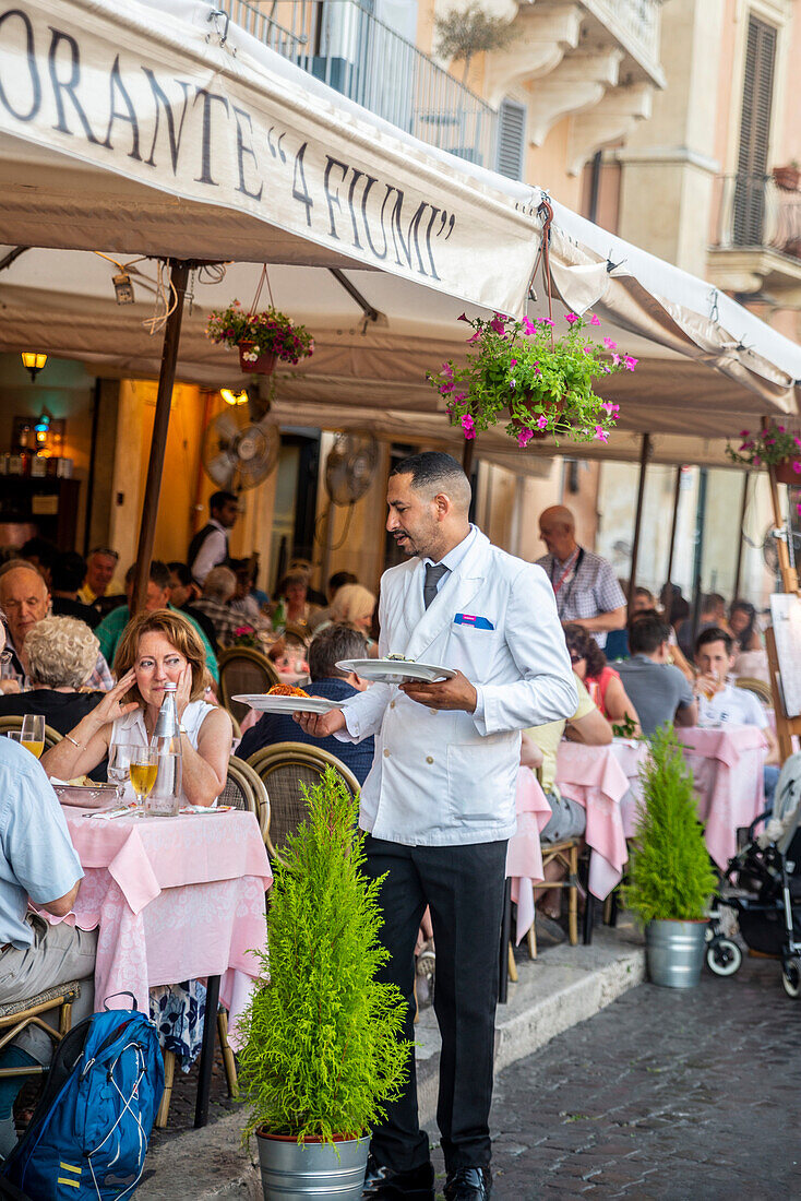 Waiter serving at outdoors restaurant table, Piazza Navona, Rome, Lazio, Italy, Europe