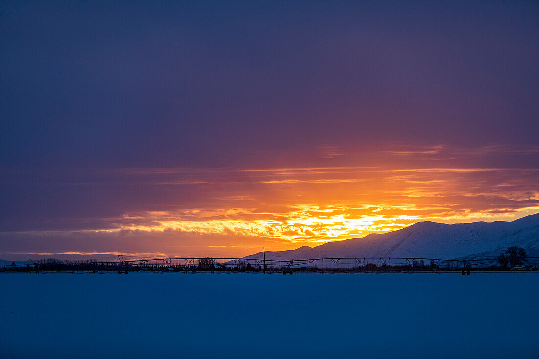 United States, Idaho, Bellevue, Sun rising above snowcapped mountains
