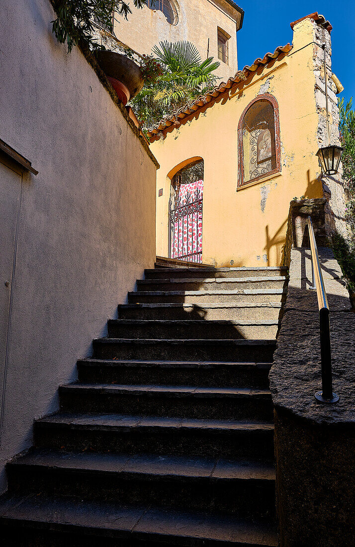 old streets, paths and culverts in the center of Gandria. Whimsical entrance doors and street lamps.