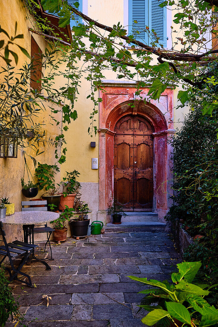 old streets, paths and culverts in the center of Gandria. Whimsical entrance doors and street lamps.