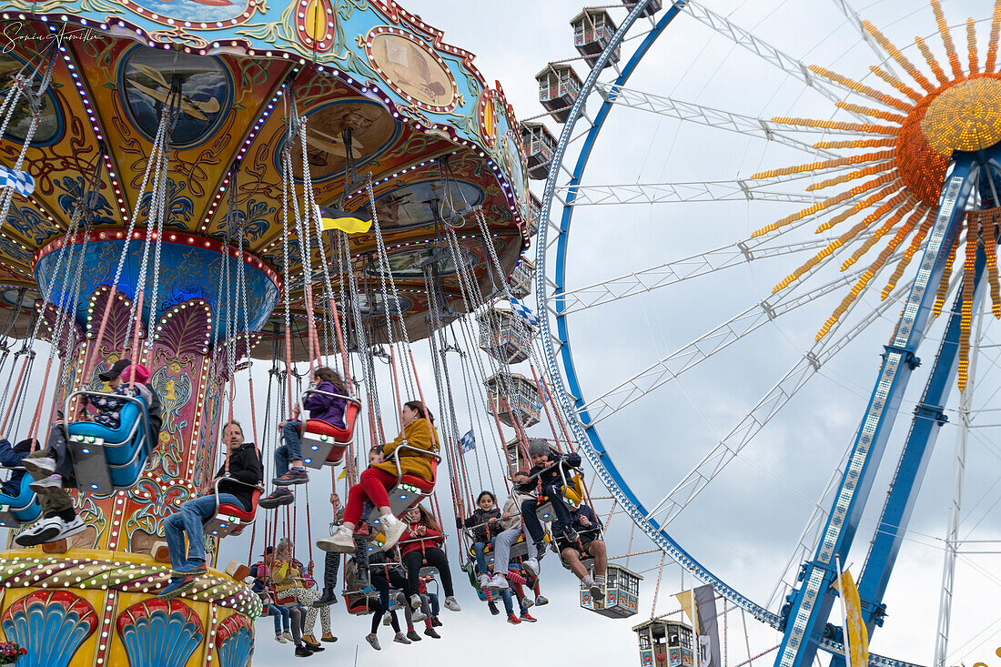 View of a carousel and the Ferris wheel, folk festival, Theresienwiese, Munich, Bavaria, Germany