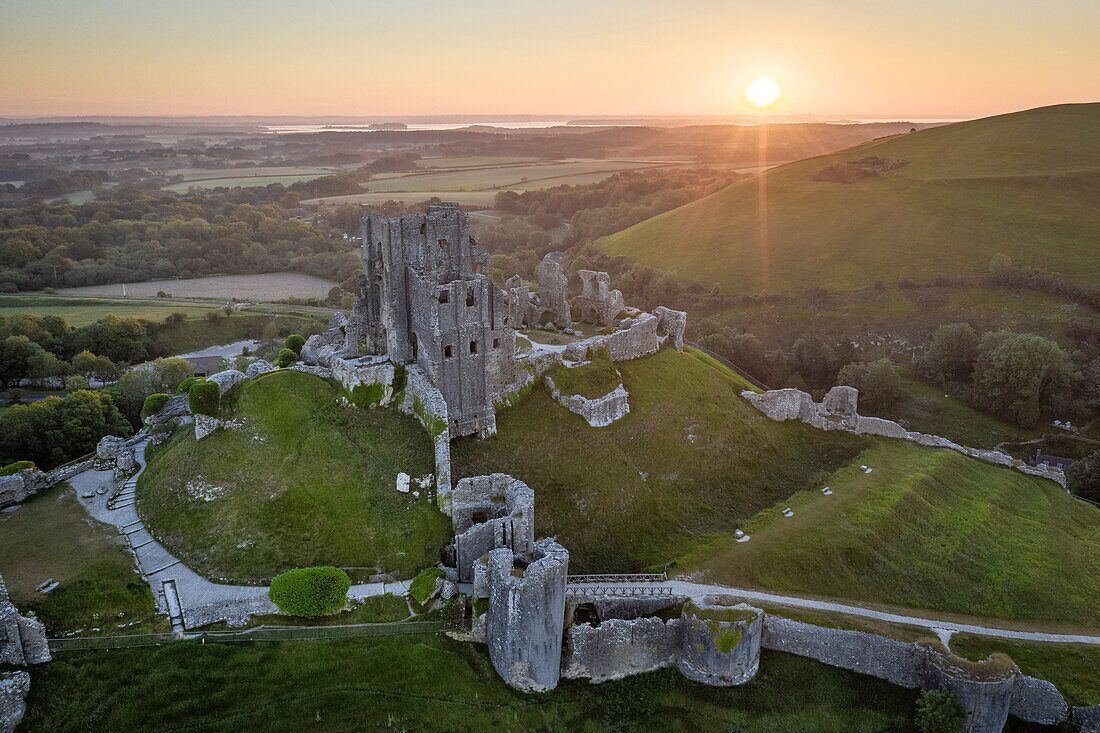 Aerial view of the abandoned ruins of Corfe Castle at sunrise, Dorset, England, United Kingdom, Europe