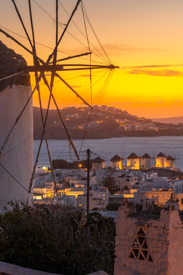 View of the windmills and town from elevated position at dusk, Mykonos Town, Mykonos, Cyclades Islands, Greek Islands, Aegean Sea, Greece, Europe