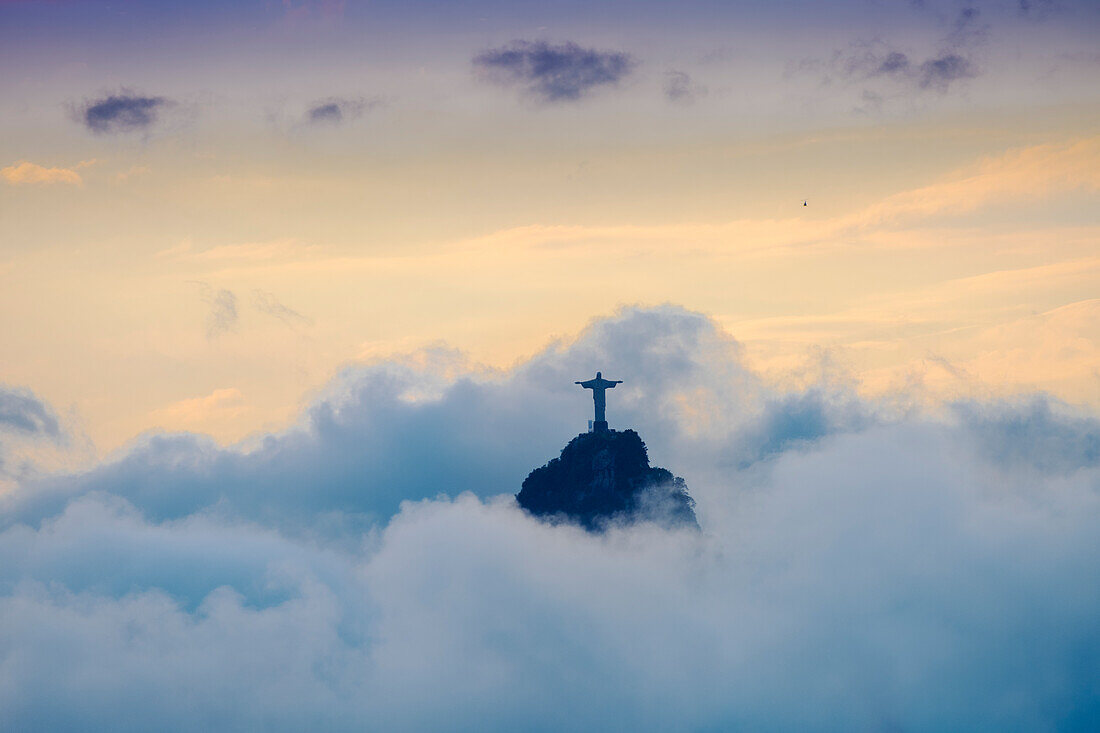 The Christ Statue (Cristo Redentor) on the summit of Corcovado mountain in a sea of clouds, Rio de Janeiro, Brazil, South America