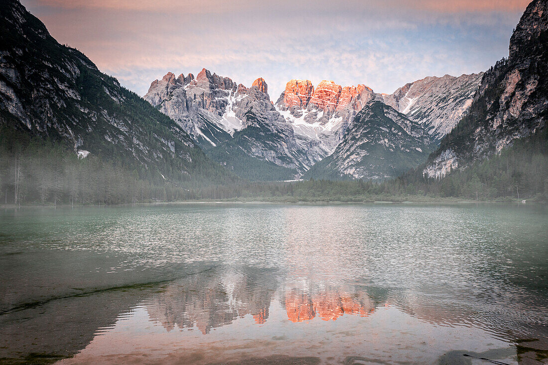Popena group and Monte Cristallo mirrored in lake Landro (Durrensee) in the mist at dawn, Dolomites, South Tyrol, Italy, Europe