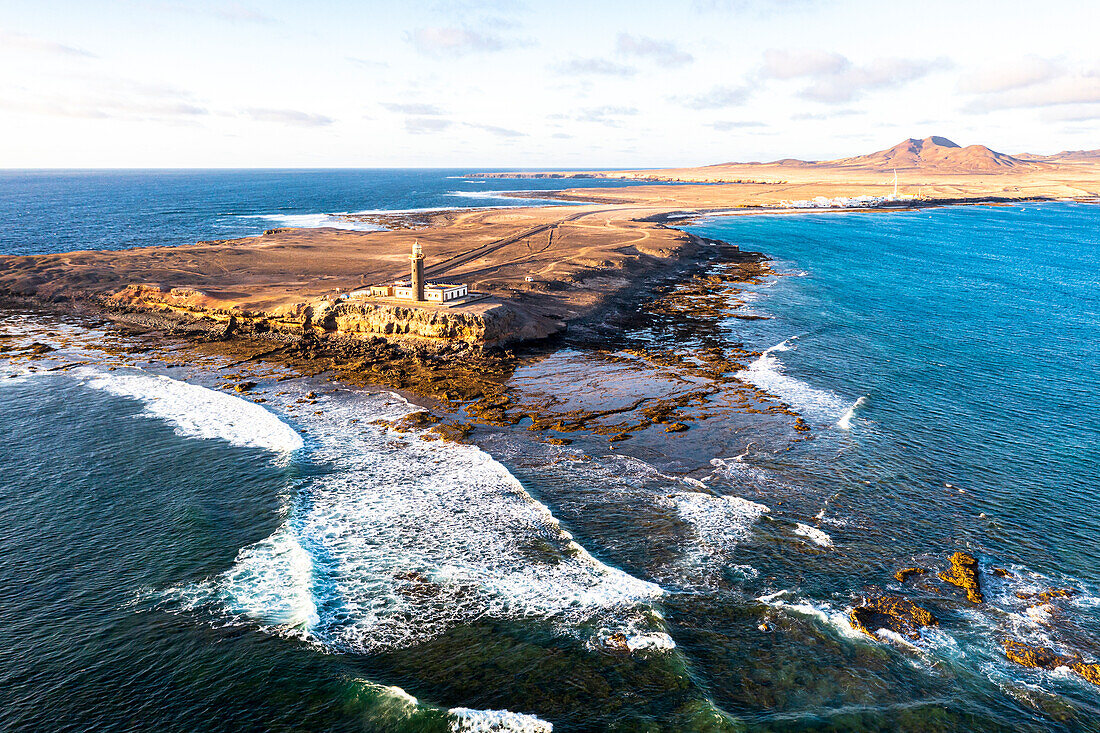 Sunset over the lighthouse of Punta Jandia (Faro de la Lola) washed by ocean waves, Fuerteventura, Canary Islands, Spain, Atlantic, Europe