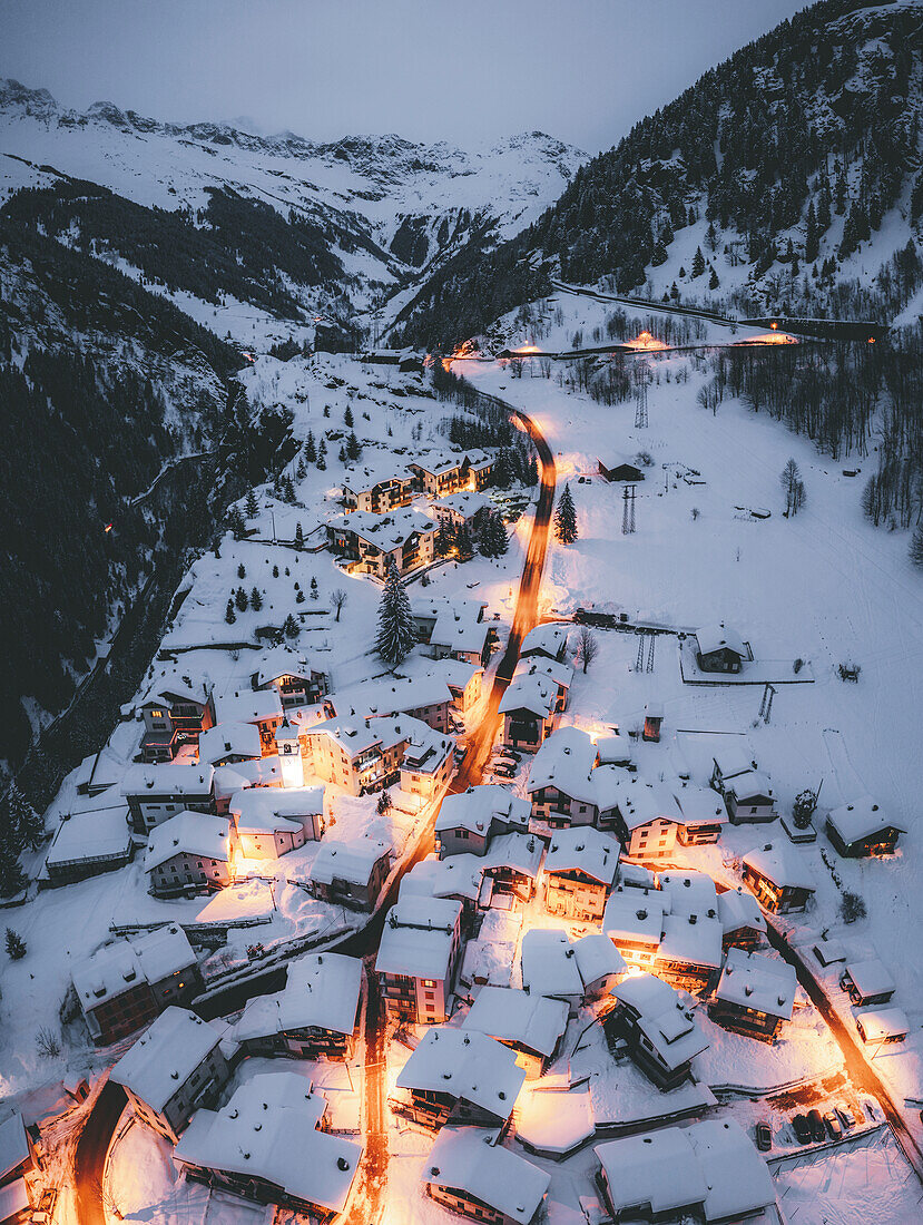 Aerial view of illuminated mountain huts covered with snow, Pianazzo, Madesimo, Valle Spluga, Valtellina, Lombardy, Italy, Europe