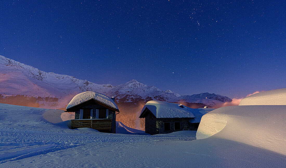 Mountain huts covered with snow during a winter starry night, Andossi, Madesimo, Valchiavenna, Valtellina, Lombardy, Italy, Europe