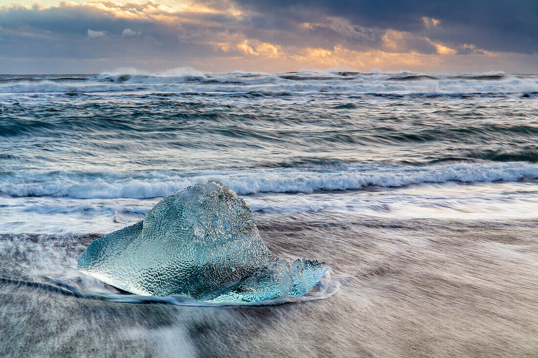 Iceberg from melting glacier on black sand beach near Jokulsarlon glacier lagoon, Vatnajokull National Park, Iceland, Polar Regions