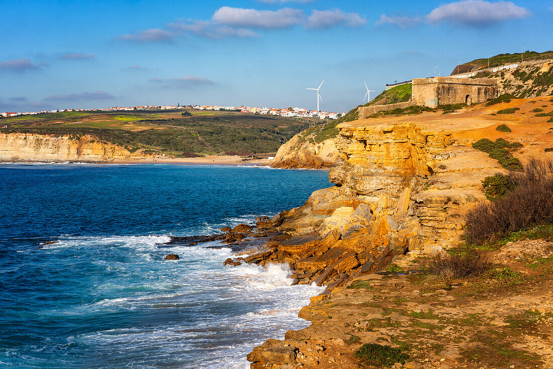 Milreu fortress on the cliff and Ribeira d'ilhas beach in Ericeira, Portugal, Europe