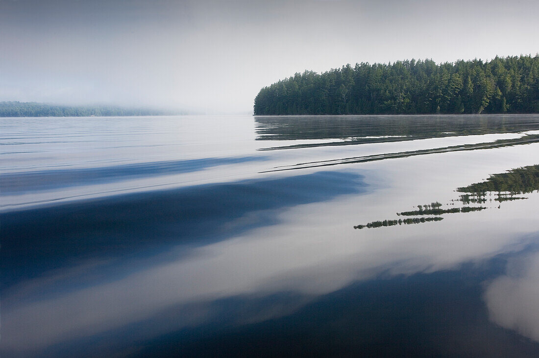 New York, Calm Upper Saranac Lake surface at dawn