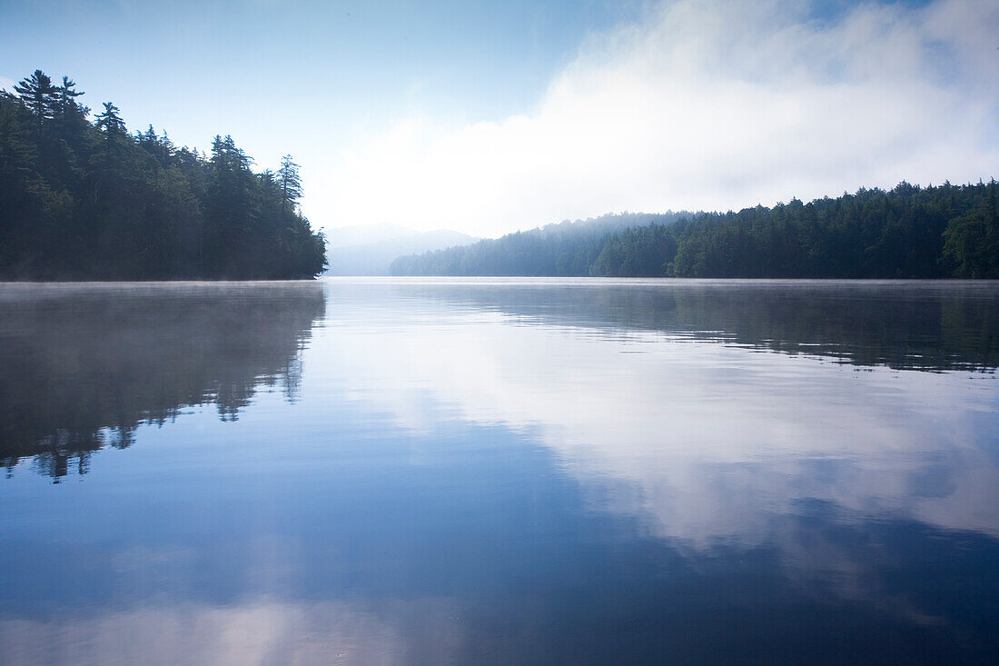 Usa, New York State, Morning fog on Upper Saranac Lake