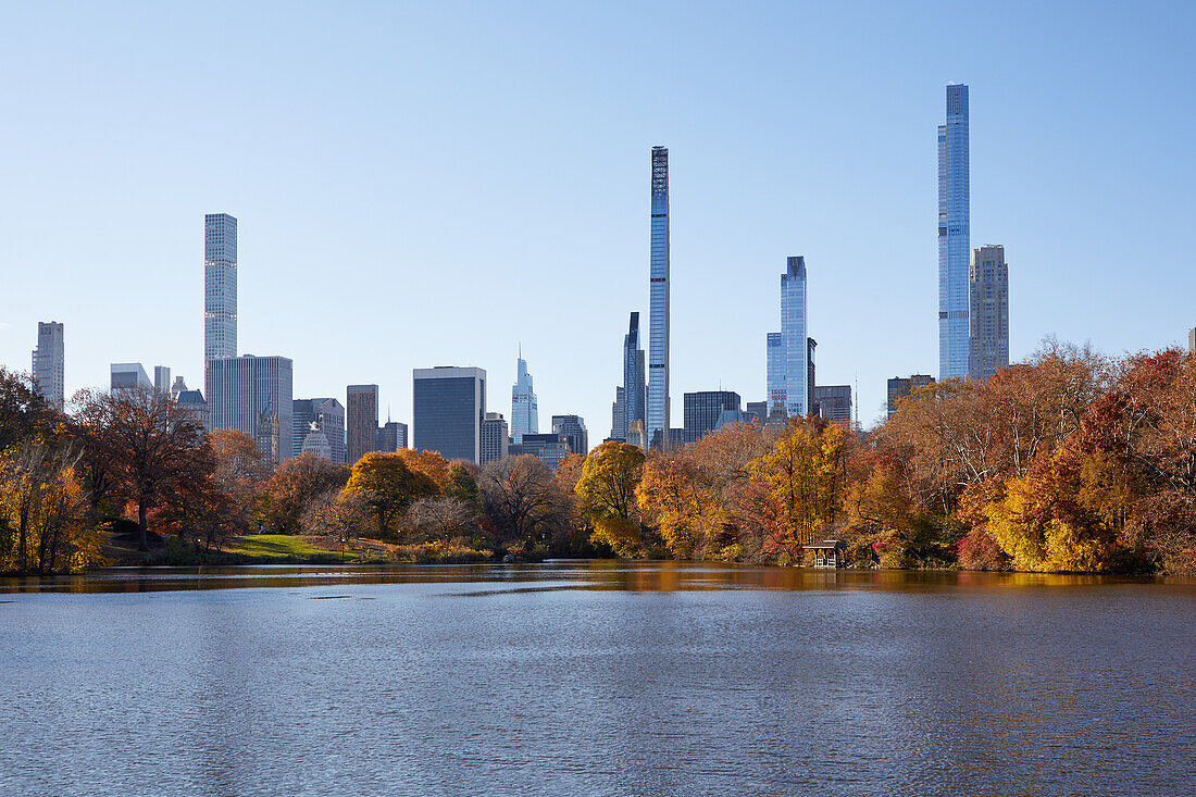 USA, New York, New York City, Midtown Manhattan skyscrapers seen across pond in Central Park
