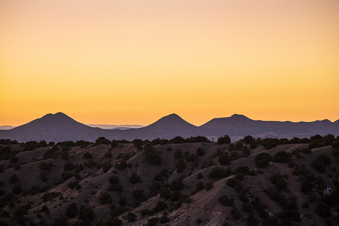 COLORFUL SKY OVER THE CERRILLOS HILLS FROM GALISTEO BASIN PRESERVE, LAMY, NM, USA