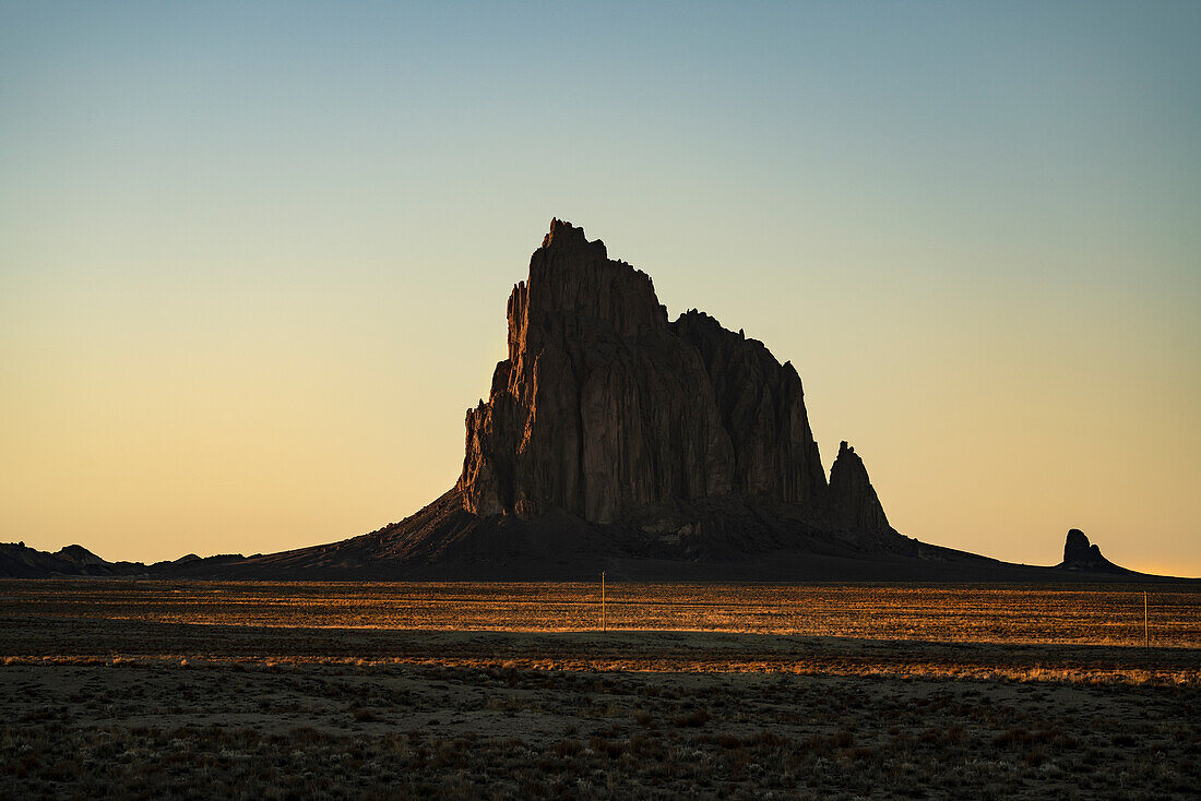 USA, New Mexico, Desert landscape with Ship Rock at sunset