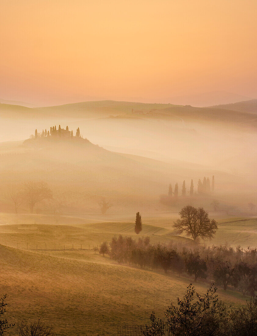 Italy, Tuscany, Val D'Orcia, Pienza, Hills covered with mist at sunrise