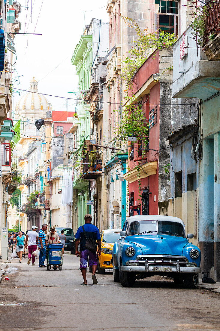 Blue vintage American car on busy street, Havana, Cuba, West Indies, Central America