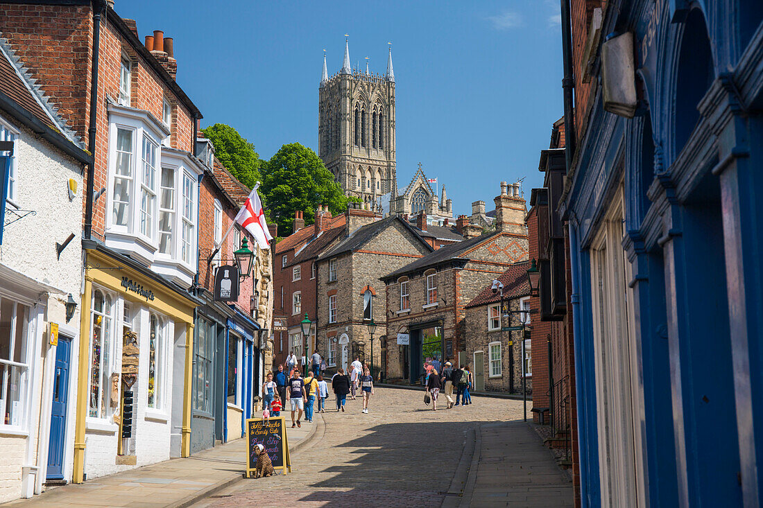 View up The Strait to Steep Hill and the central tower of Lincoln Cathedral, Lincoln, Lincolnshire, England, United Kingdom, Europe