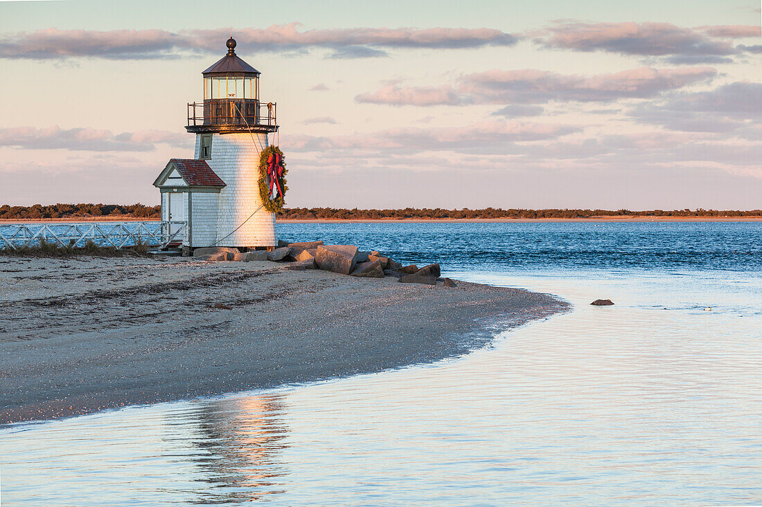 USA, Massachusetts, Nantucket Island. Nantucket Town, Brant Point Lighthouse with a Christmas wreath at dusk.