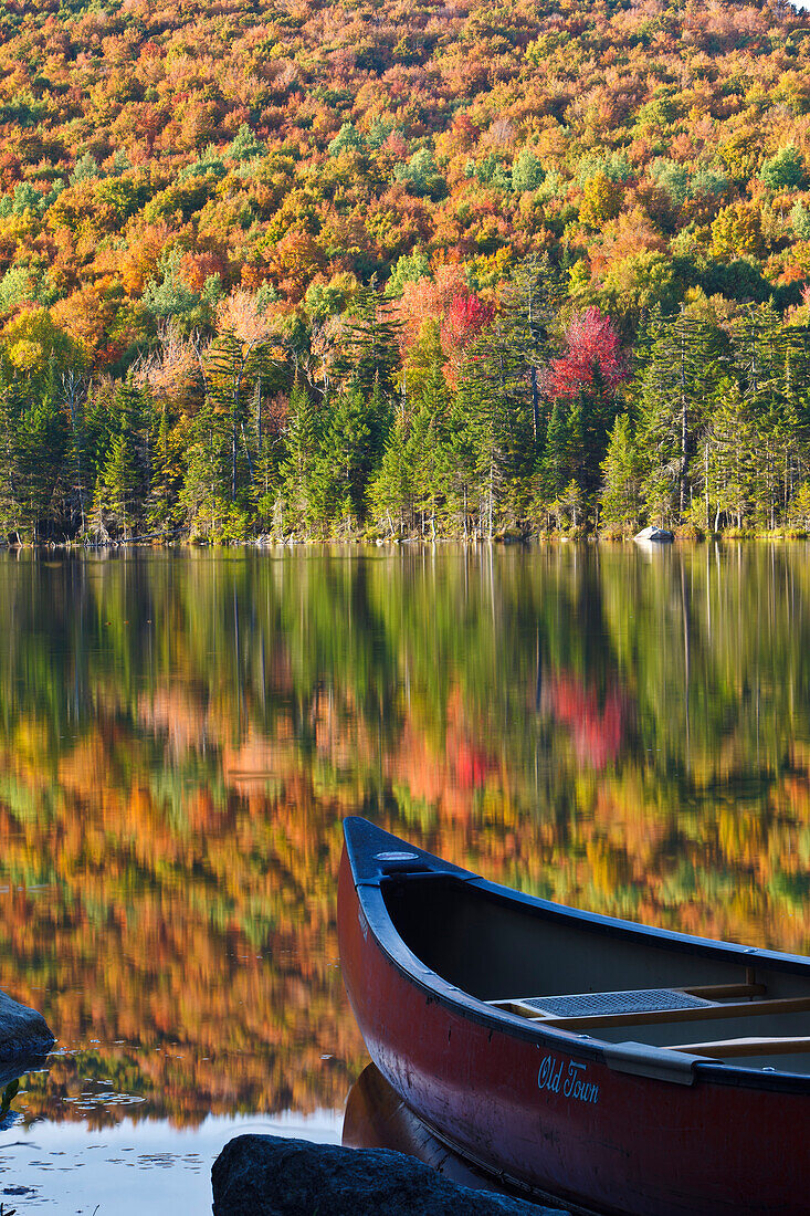 A canoe on the shoreline of Pond of Safety in the Randolph Community Forest. in New Hampshire's White Mountains.
