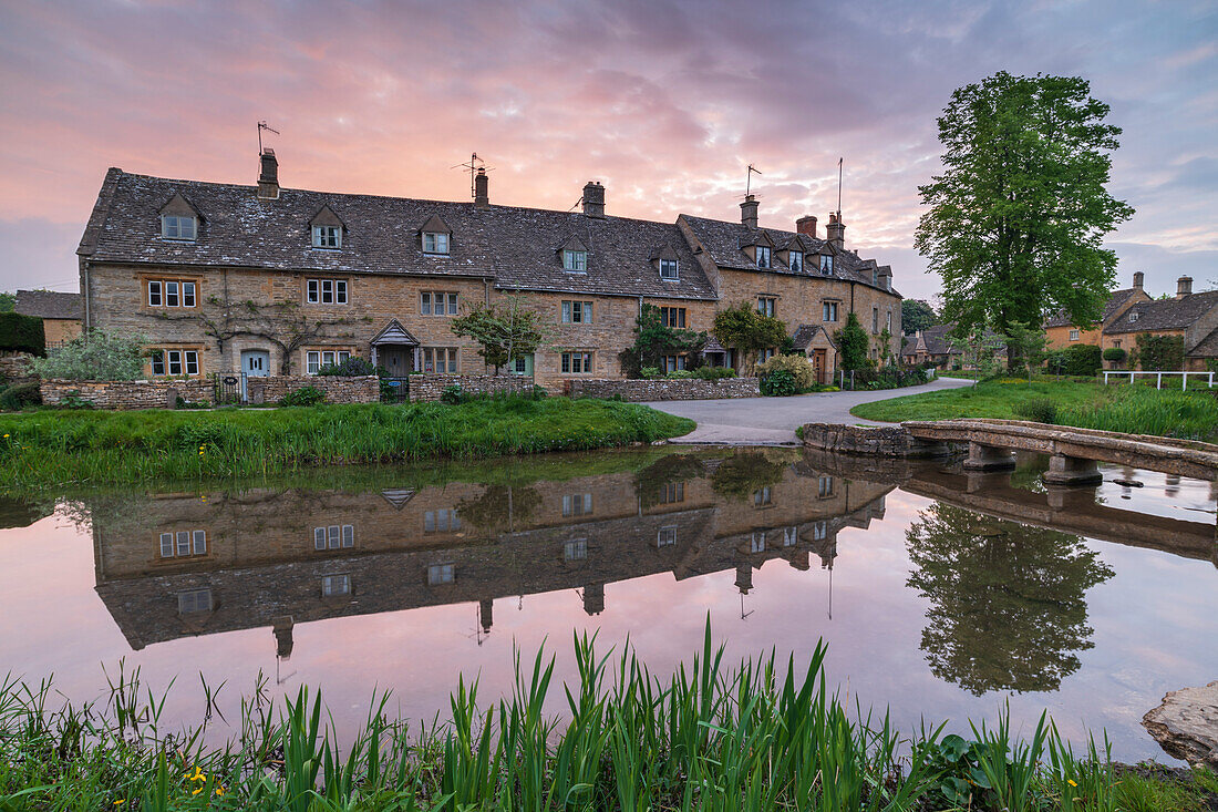 Pretty Cotswolds cottages reflected in the River Eye at dawn in spring in the village of Lower Slaughter, Gloucestershire, England, United Kingdom, Europe
