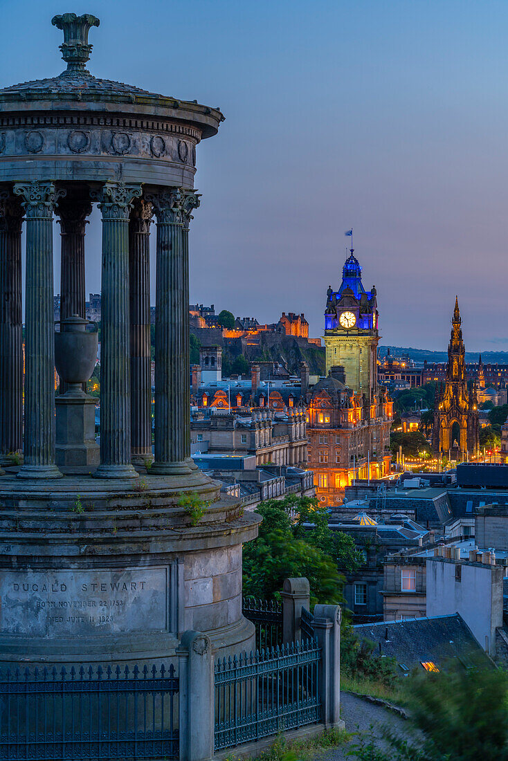 View of Edinburgh Castle, Balmoral Hotel and Dugald Stewart monument from Calton Hill at dusk, UNESCO World Heritage Site, Edinburgh, Lothian, Scotland, United Kingdom, Europe