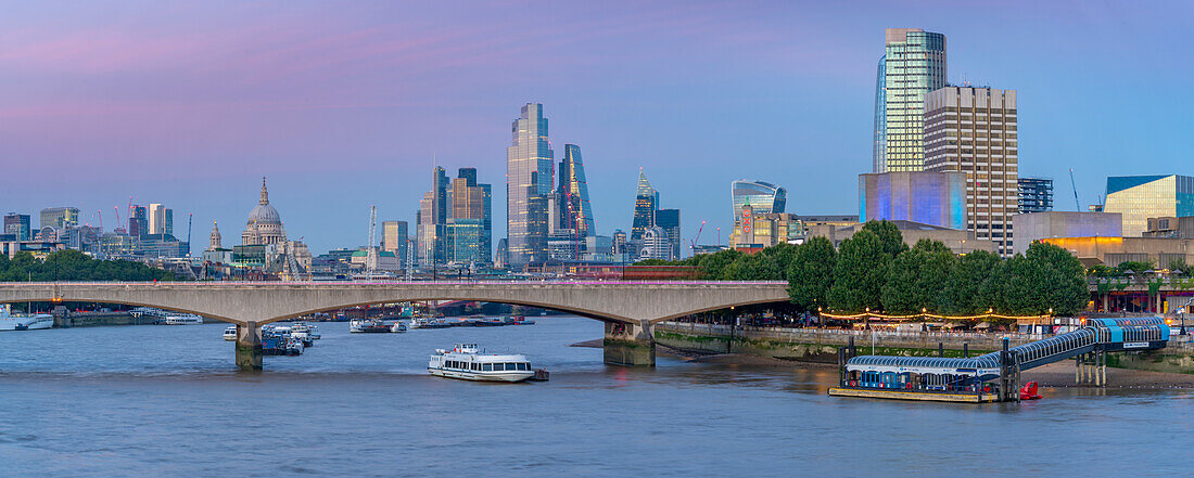 View of Waterloo Bridge over the River Thames, St. Paul's Cathedral and The City of London skyline at dusk, London, England, United Kingdom, Europe