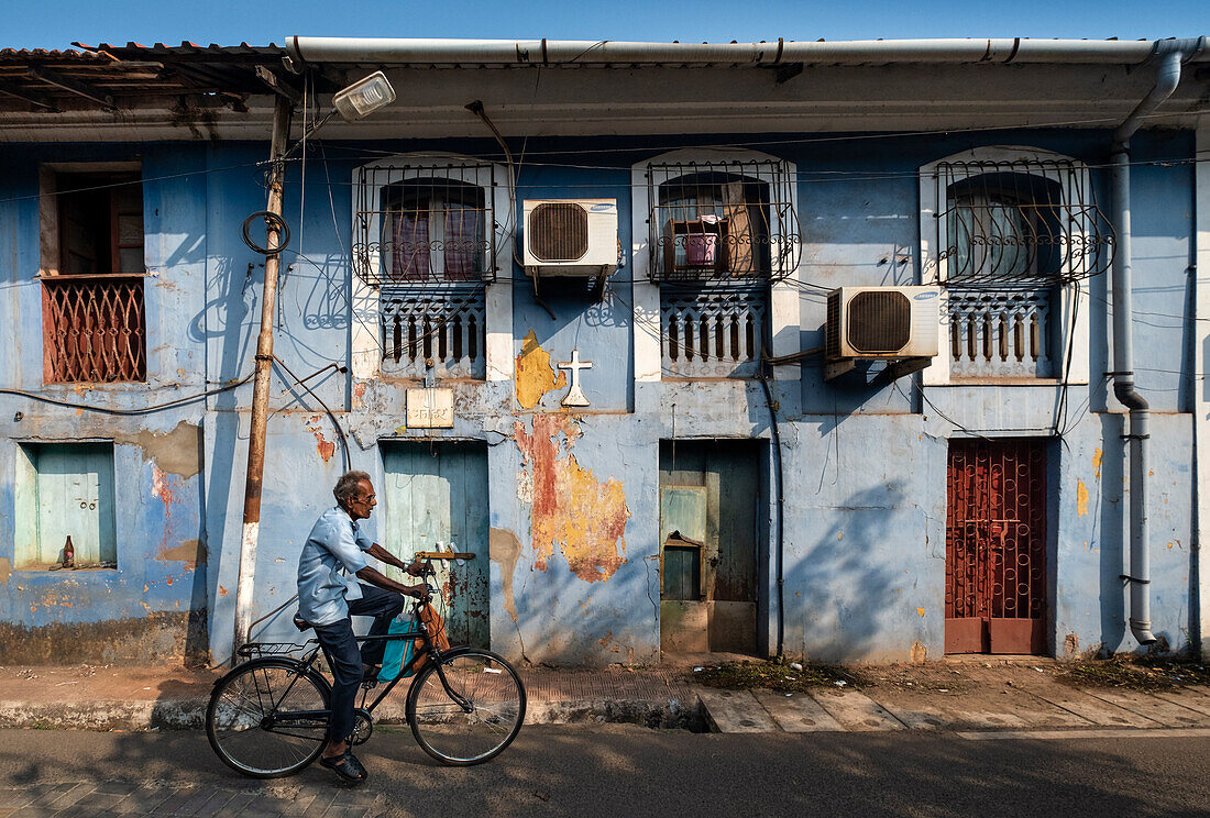 Local Man on a bicycle in the backstreets, Panjim City, Panjim (Panaji), Goa, India, Asia