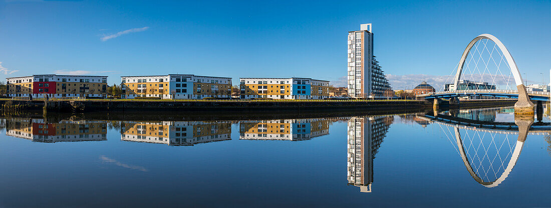 Panoramic reflection of Clyde Arc (Squinty Bridge) and flats, River Clyde, Glasgow, Scotland, United Kingdom, Europe