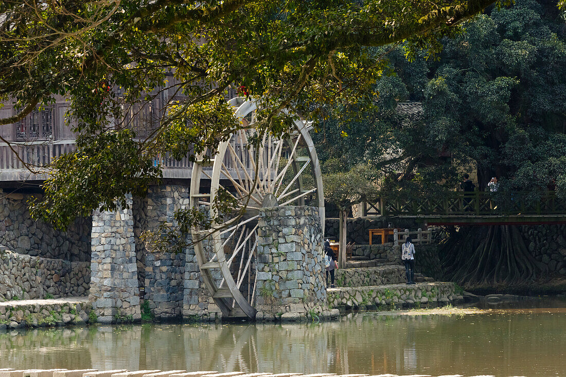 Traditional house and water wheel by the river in Yunshuiyao Village, Nanjing County, Fujian Province, China