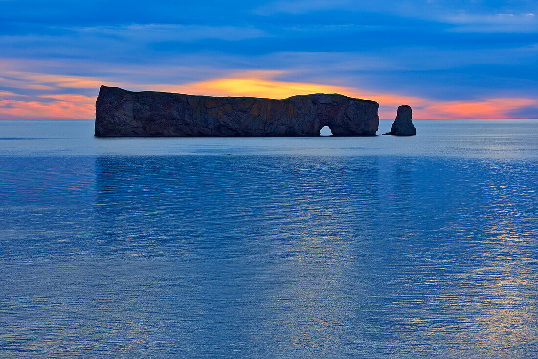 Canada, Quebec, Perce. Perce Rock in Atlantic Ocean at sunset.