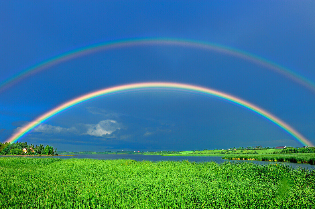 Canada, Quebec, St. Gedeon. Double rainbow after storm.