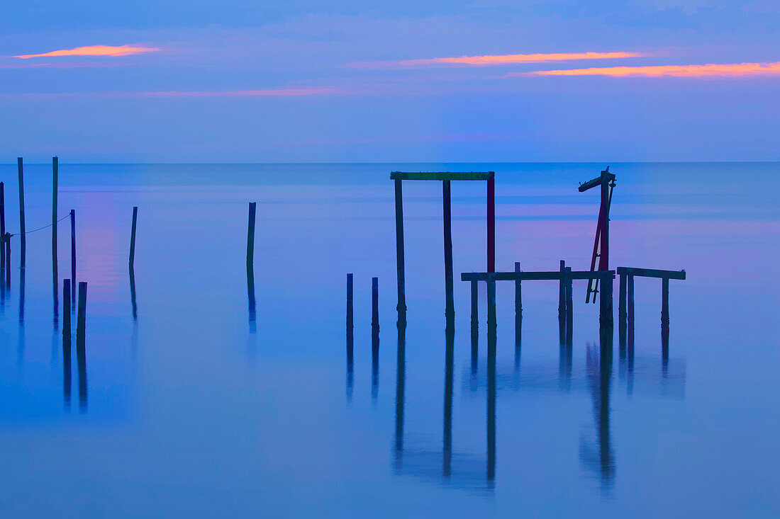 USA, Florida, Apalachicola. Remains of an old dock at sunrise.