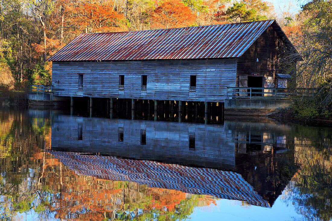 USA, Georgia, Grist mill with fall reflections in pond..