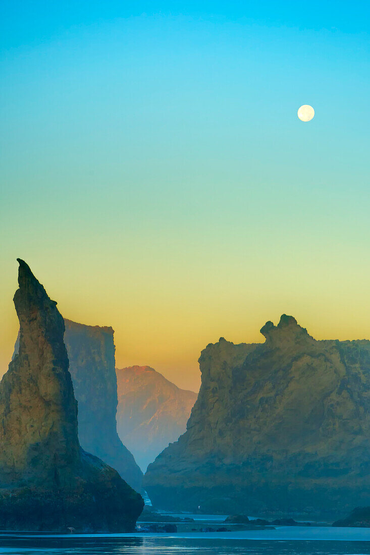 USA, Oregon, Bandon. Moonset and sea stacks.