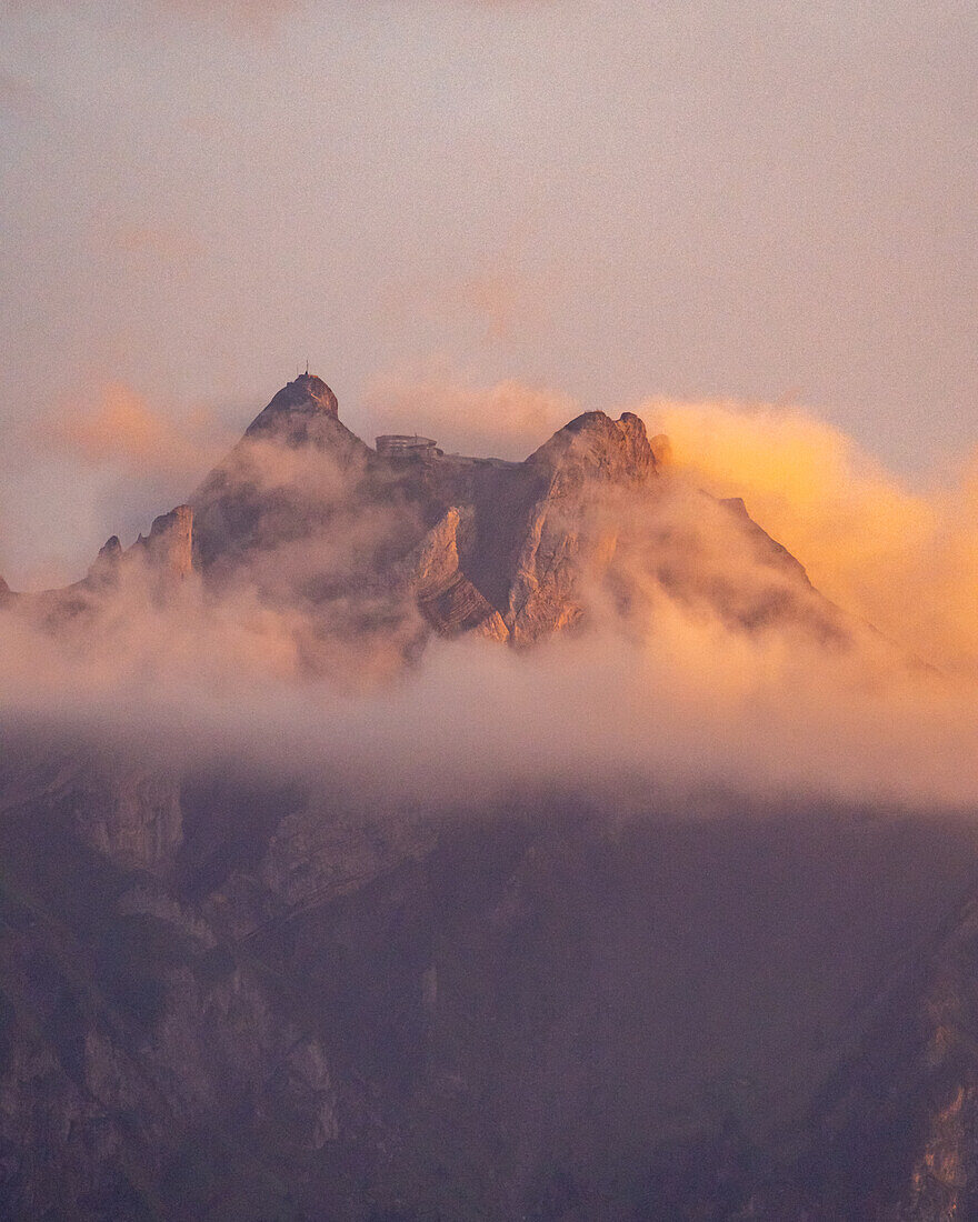 Die Gipfel am Pilatus-Kulm in Wolken mit Himmelsröte, Kanton Luzern, Schweiz, Europa