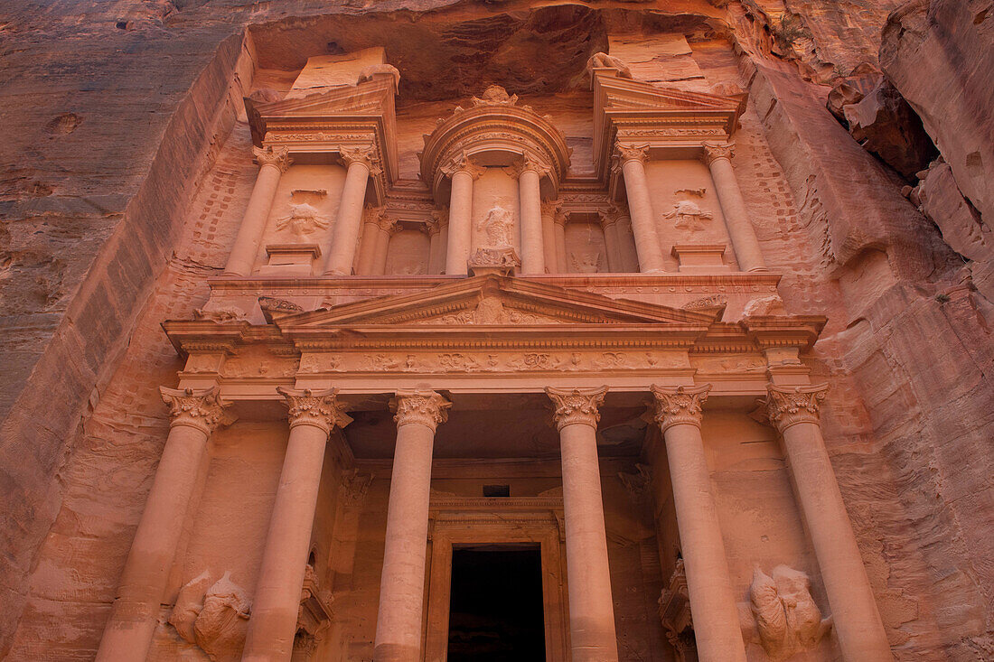 Jordan, Petra. Looking up at the massive face of the Treasury which was cut out of the sandstone as a single piece.