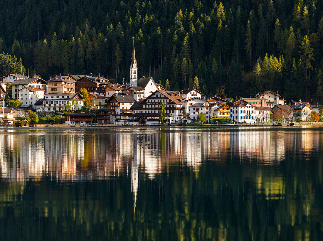 Village Alleghe at Lago di Alleghe at the foot of mount Civetta, one of the icons of the Dolomites of the Veneto. Part of the UNESCO World Heritage Site, Italy