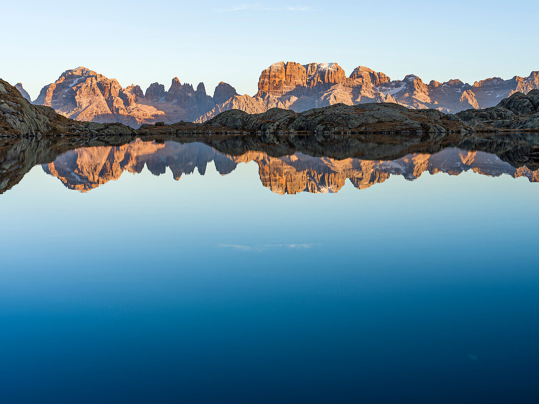 The summits of Brenta mountain range are reflected in Lago Nero. Brenta group in the Dolomites, part of UNESCO. Europe, Italy, Val Rendena