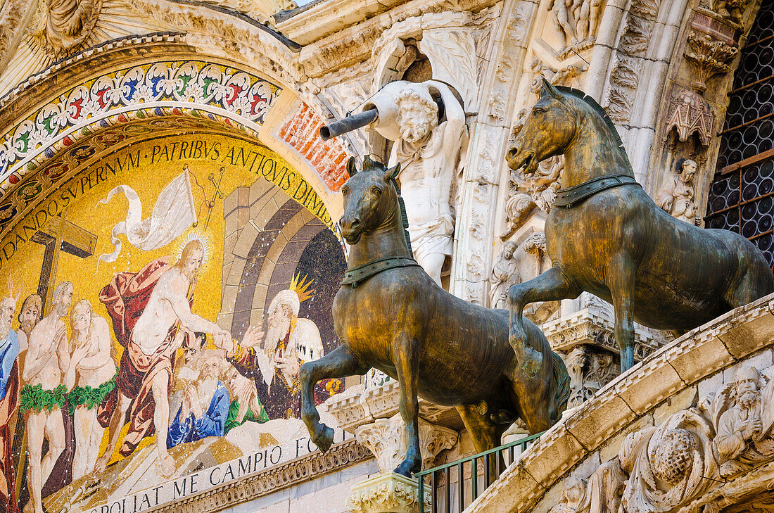 Bronze horses and mosaic above the entrance to Basilica San Marco (Saint Mark's Cathedral), Venice, Veneto, Italy
