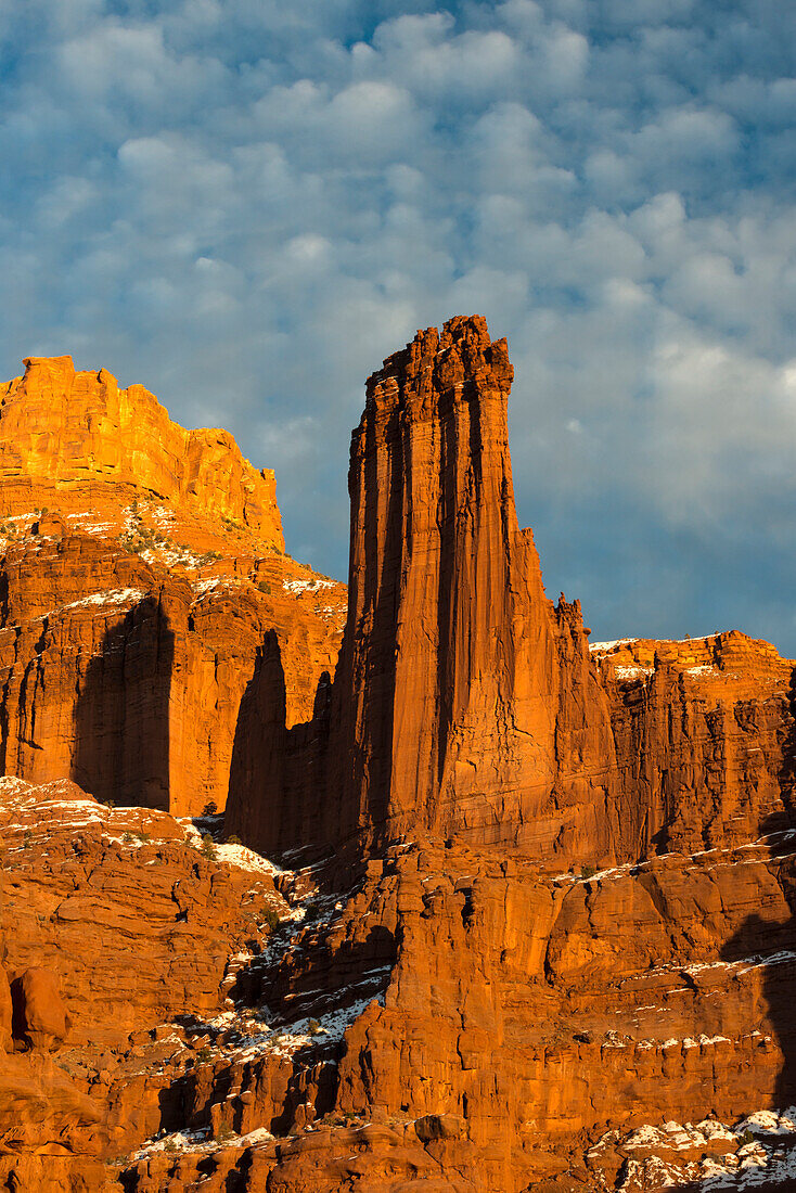 USA, Utah. Fisher Towers with clouds and snow at sunset, near Castle Valley ()