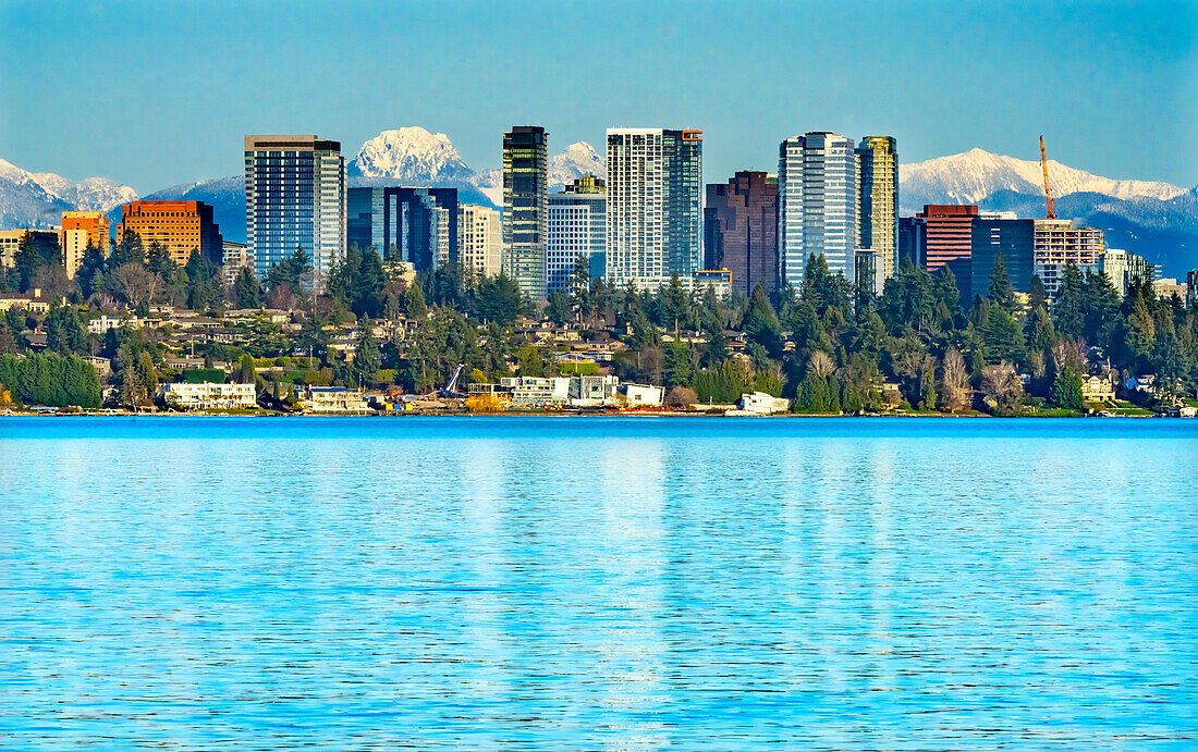 High-rise buildings, Lake Washington and snowcapped Cascade Mountains, Bellevue, Washington State.