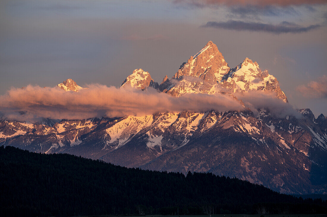 USA, Wyoming, Grand Teton National Park. Storm clouds over Grand Teton Range at sunset.