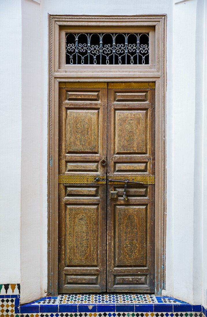 decorated wooden door in bahia palace in marrakesh