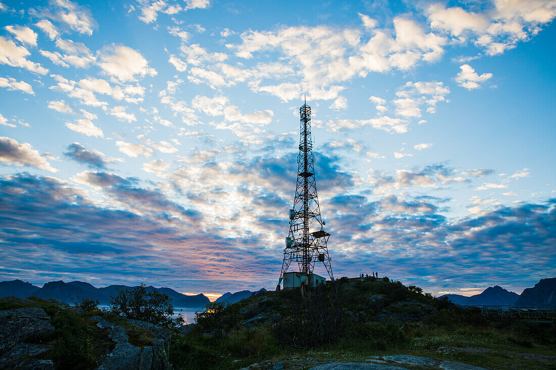 Norway, Lofoten, transmission tower in the sunset over the fjord