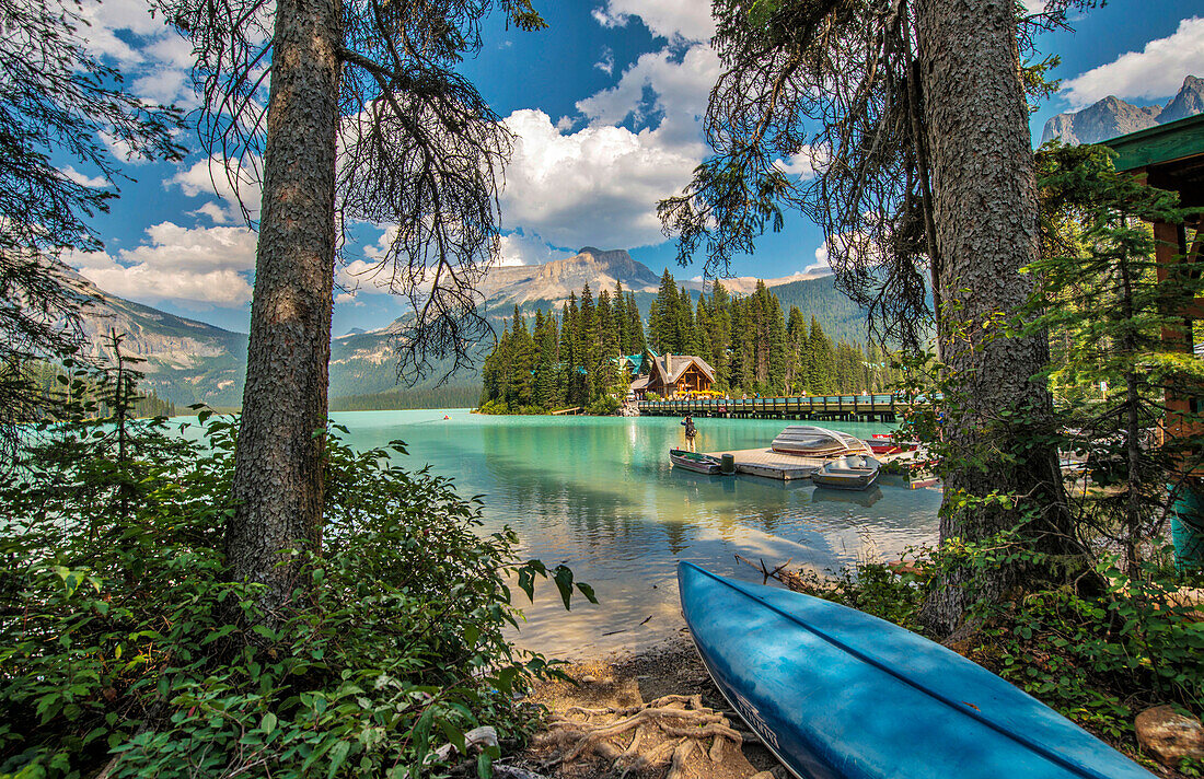 Blue canoe on shore of Emerald lake in Yoho National Park, Canada.