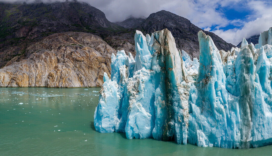 USA, Alaska, Tracy Arm-Fords Terror Wilderness, Aerial view of blue face of Dawes Glacier on summer morning