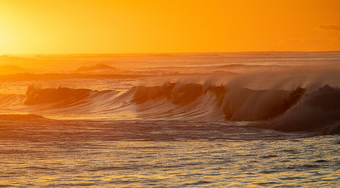 Incoming surf waves at sunrise near Poipu in Kauai, Hawaii, USA