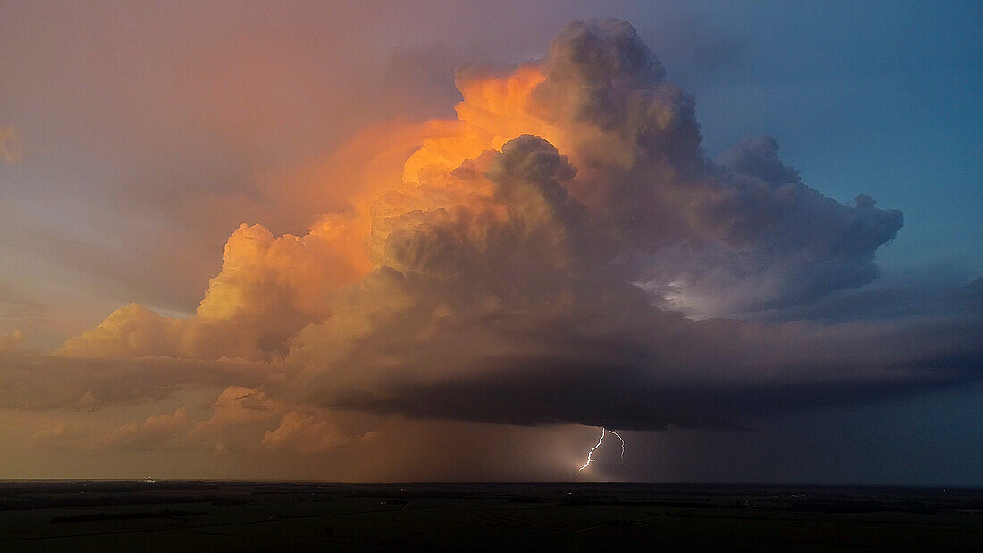 Aerial view of thunderstorm clouds and lightning at sunset, Marion County, Illinois.