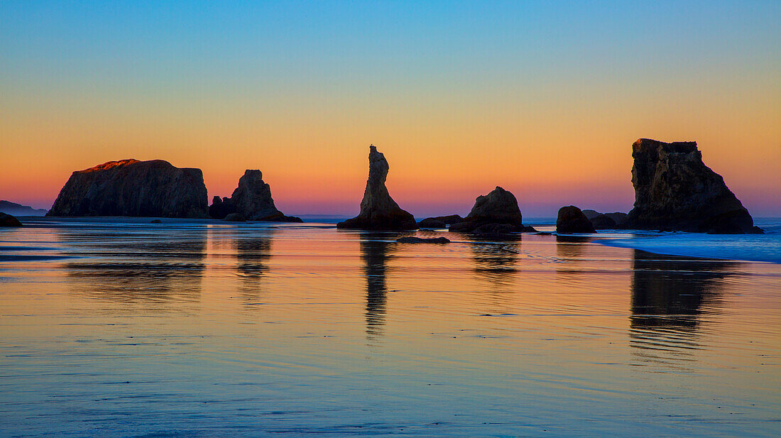 USA, Oregon, Bandon. Sunset on beach sea stacks